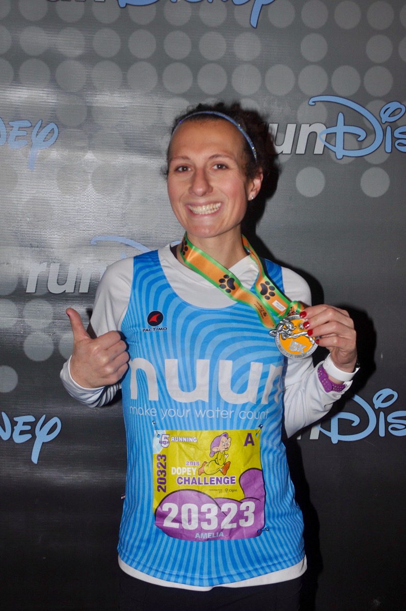 Amelia after the 2018 Disney World 5k holding her medal